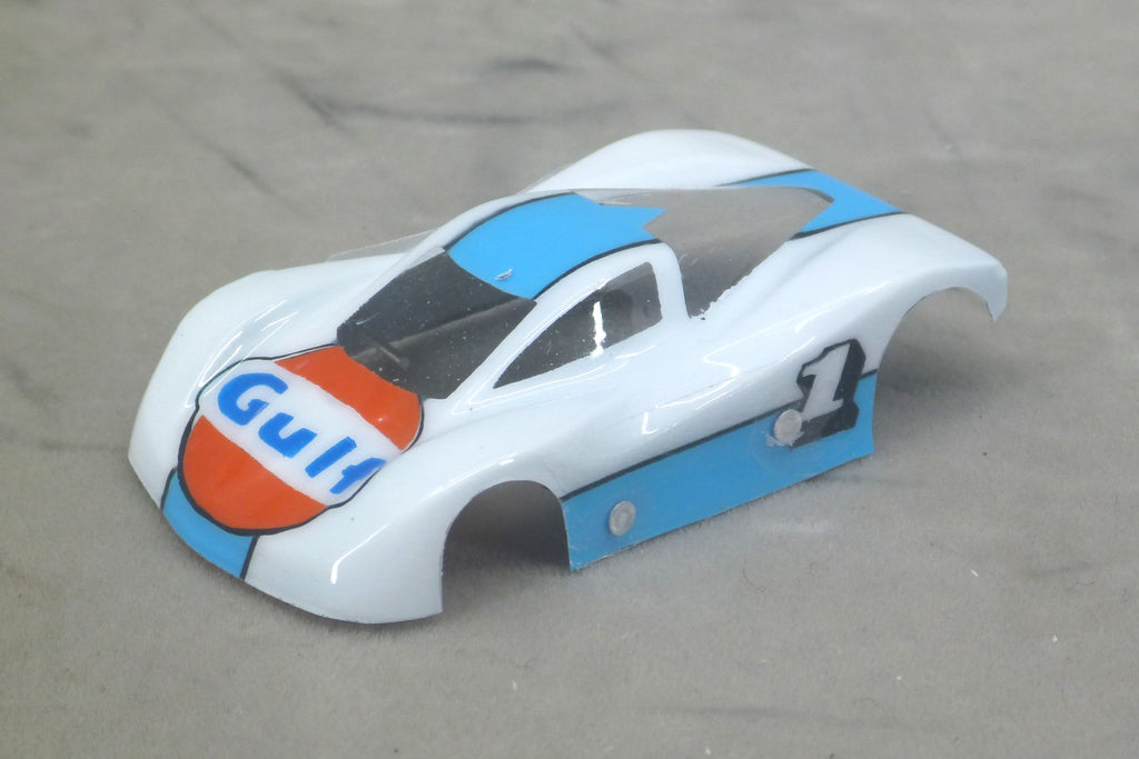 Front three-quarter view of white Gulf painted Lexan HO slot car body with blue accents, orange Gulf hood logo and number 1