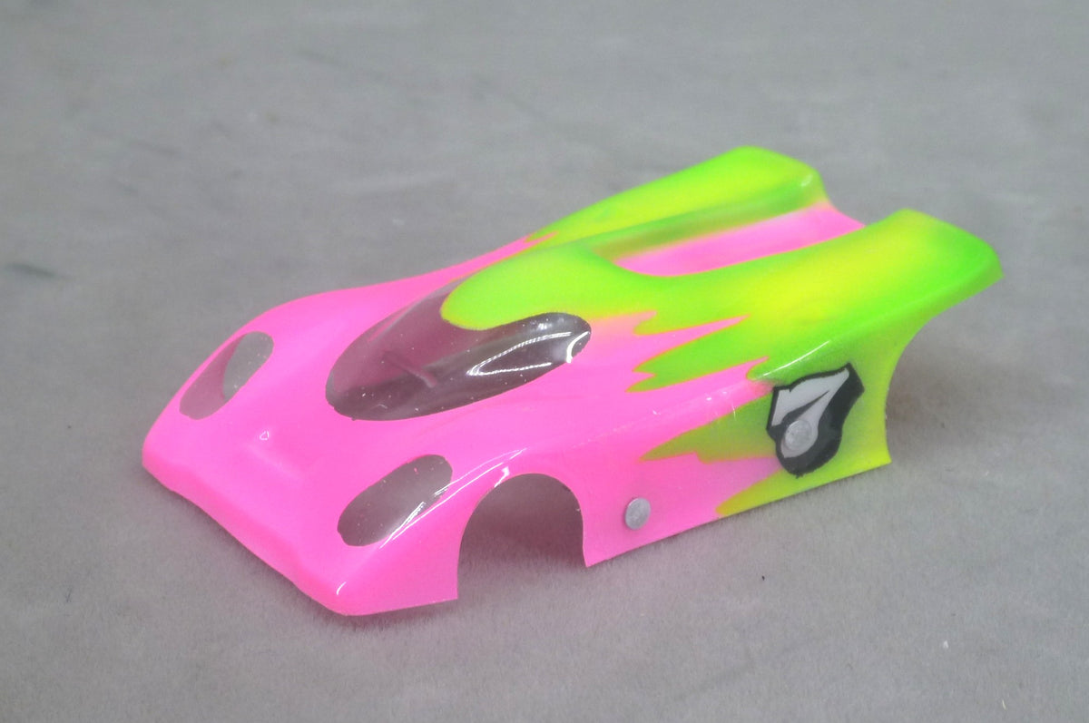 Front three-quarter view of pink and lime green Toxic Pop Flame Sweep painted Lexan HO slot car body with swept flame edges and side number