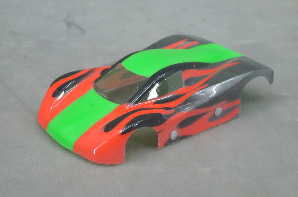 Front three-quarter view of Shadow Flame painted Lexan HO slot car body with green center stripe, red panels and black flames