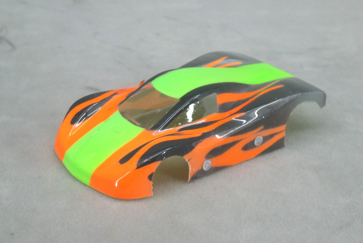 Front three-quarter view of Shadow Flame painted Lexan HO slot car body with lime green center stripe, orange panels and black flames