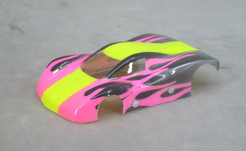 Front three-quarter view of Shadow Flame painted Lexan HO slot car body with yellow center stripe, fuchsia pink panels and black flames