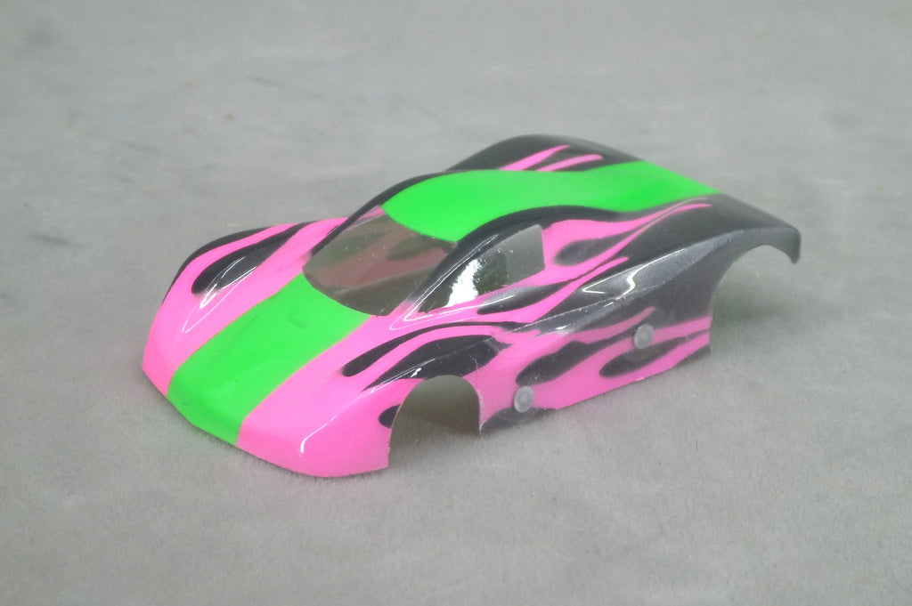 Front three-quarter view of green and pink Shadow Flame painted Lexan HO slot car body with black flame graphics