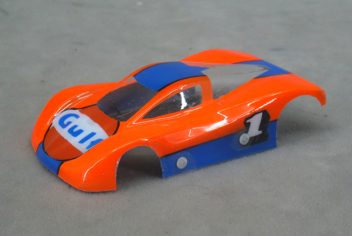Front three-quarter view of orange Gulf #1 painted Lexan HO slot car body with dark blue accents and Gulf hood logo