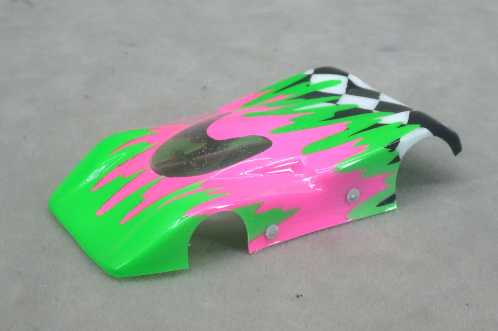 Front three-quarter view of green and fuchsia Checkered Surge painted Lexan HO slot car body with checkerboard tail