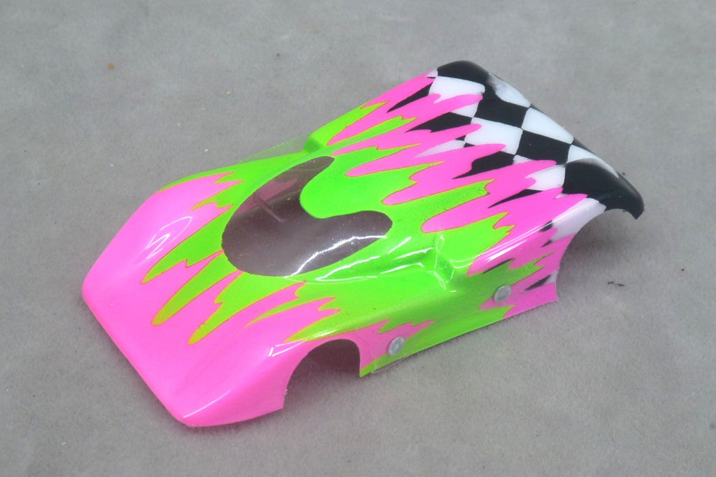 Front three-quarter view of fuchsia and green Checkered Surge painted Lexan HO slot car body with checkerboard tail