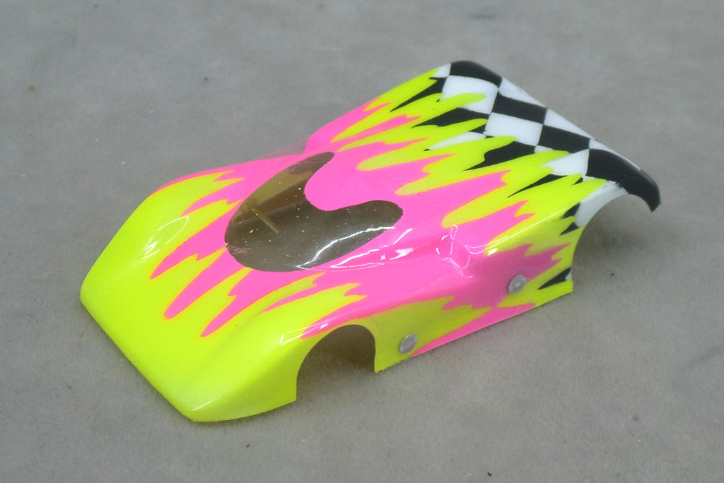 Front three-quarter view of yellow and fuchsia Checkered Surge painted Lexan HO slot car body with checkerboard tail