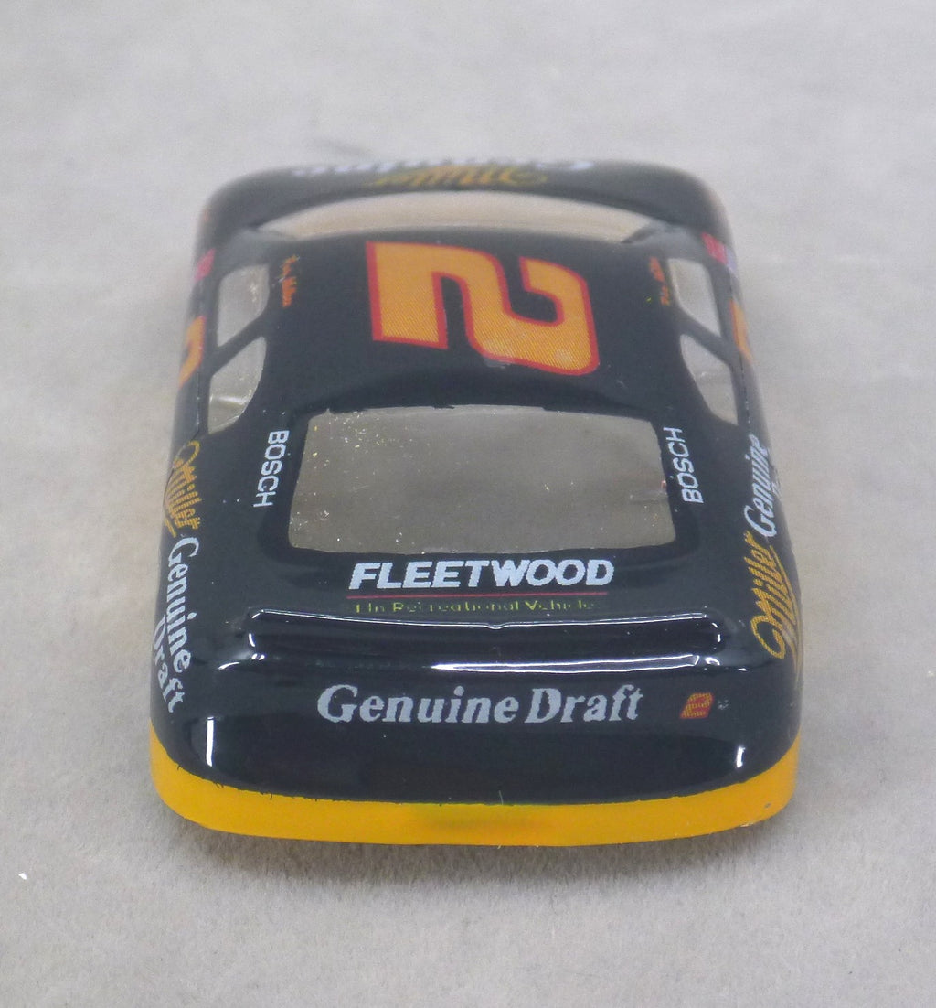 A lexan model race car body shell, specifically a Miller #2 stock car, featuring a black base with orange, yellow, and white sponsor decals including Genuine Draft, Bosch, and Miller Genuine Draft.