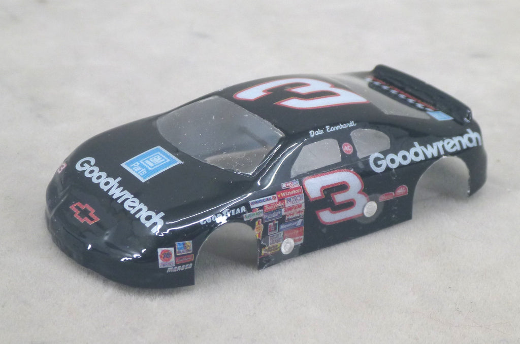 A black lexan model race car body with Goodwrench and Chevrolet branding, featuring the number 3 on the roof and side, displayed on a light gray textured surface.