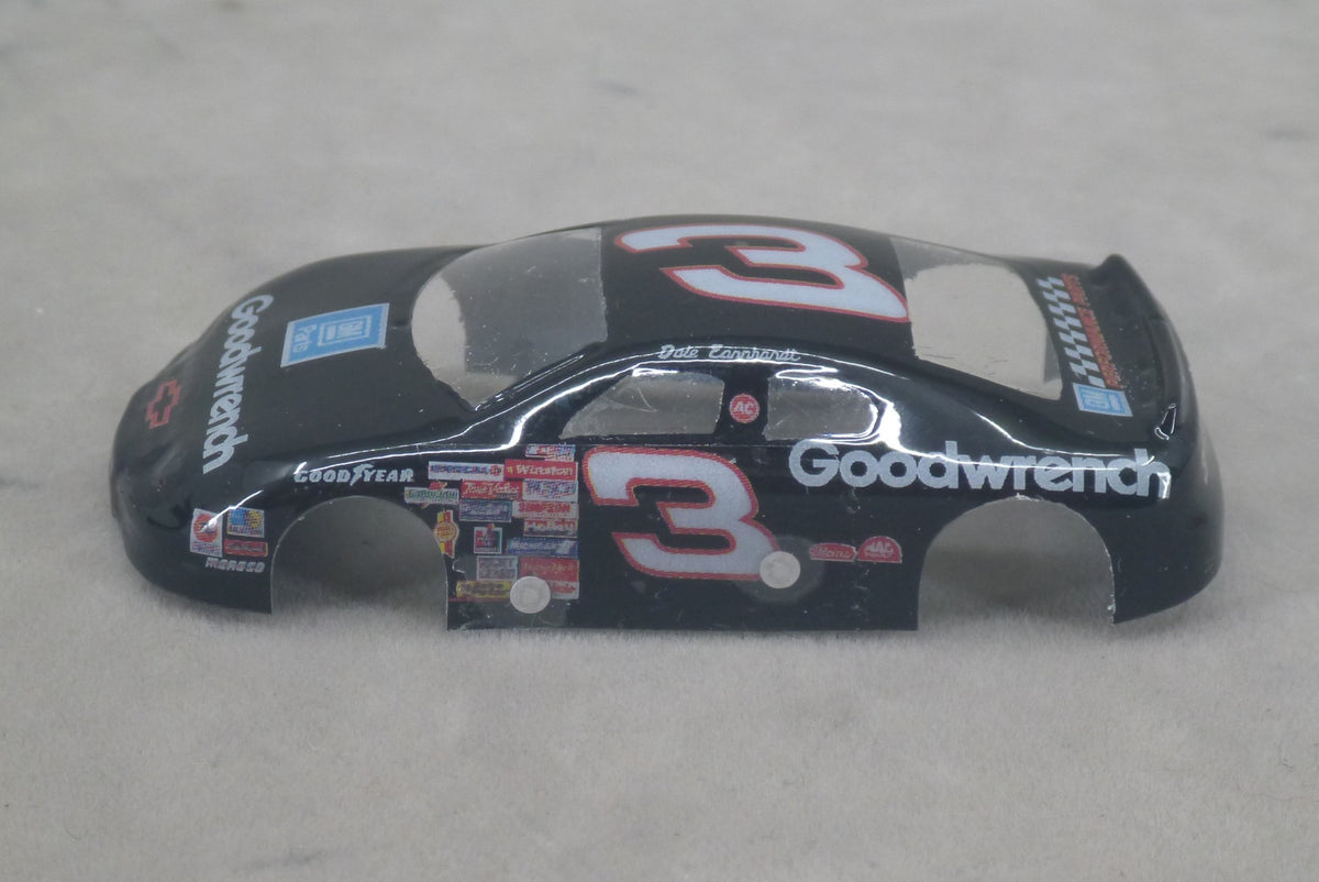 A black lexan model race car body shell featuring the number 3, Goodwrench branding, and various sponsor decals, displayed on a neutral gray background.