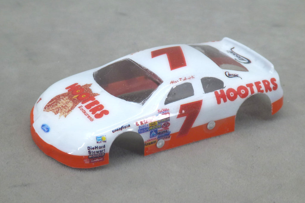 Front three-quarter view of white and orange Hooters #7 painted Lexan HO slot car body